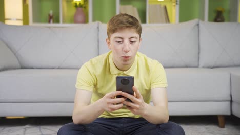 Young-man-using-phone-in-happy-mood.
